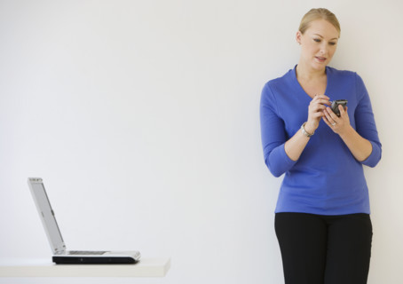 Businesswoman using electronic organizer.