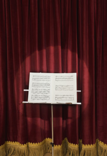 Spotlight on sheet music on stage.