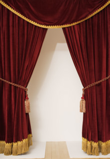 Screen behind open stage curtains.