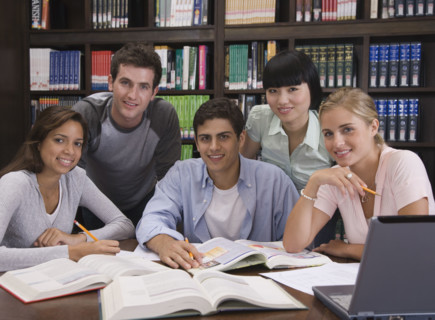 College students studying in library.