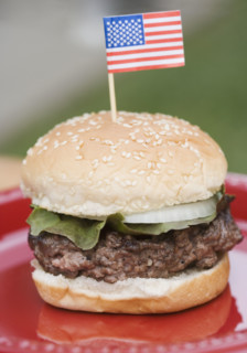 Still life of hamburger with small US flag. Date : 2006