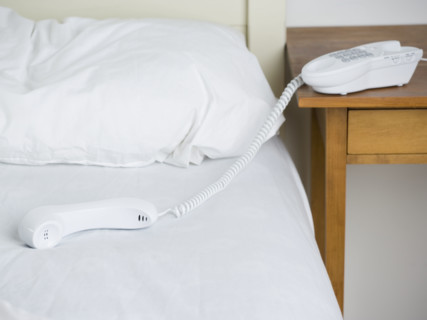 Empty bed with telephone. Date : 2006