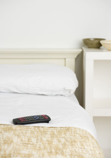 Still life of remote control on bed. Date : 2006