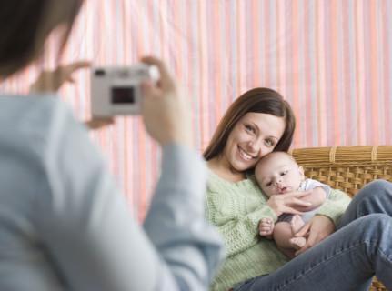 Mother and baby having their photograph taken. Date : 2006