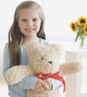 Portrait of girl hugging teddy bear. Date : 2006