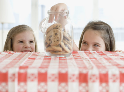 Sisters taking cookies from jar. Date : 2006