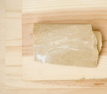 Close up of sandpaper on wood. Date : 2006