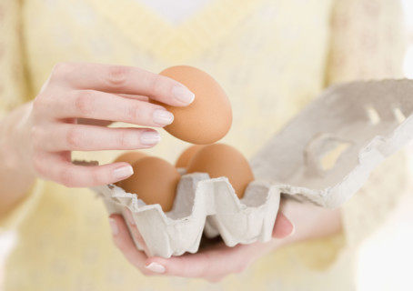 Woman holding carton of eggs. Date : 2007
