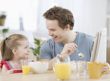 Father and daughter eating breakfast. Date : 2007