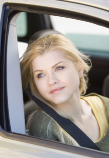 Woman sitting in passenger side of car. Date : 2007