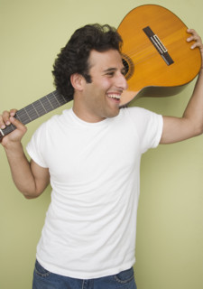 Man laughing and holding guitar. Date : 2007