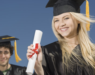 Woman wearing graduation cap and gown with diploma. Date : 2007