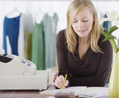 Clothing store sales clerk doing paperwork. Date : 2007