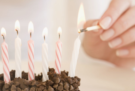Woman lighting birthday candles. Date : 2007