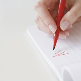 Teacher writing A plus on paper. Date : 2007