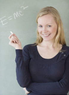 Woman standing in front of blackboard. Date : 2007
