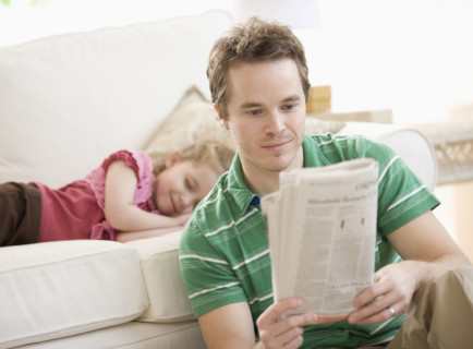 Father and daughter relaxing in livingroom. Date : 2007