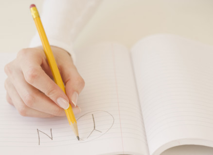 Woman circling the letter Y in notebook. Date : 2007