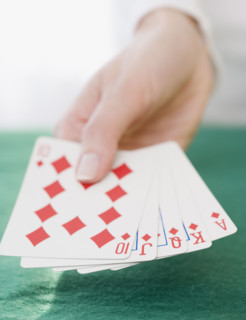 Woman holding straight flush playing cards. Date : 2007