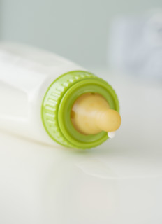 Close up of baby bottle dripping. Date : 2007