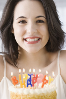 Portrait of woman next to birthday cake. Date : 2007