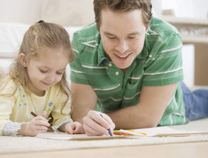 Father and daughter coloring on floor. Date : 2007