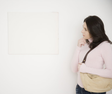 Woman looking at blank picture on wall. Date : 2007