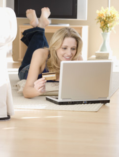 Woman shopping online on floor. Date : 2007