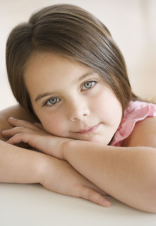 Portrait of girl leaning head on arms. Date : 2006