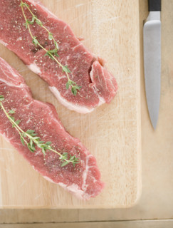 High angle view of meat and spices on cutting board. Date : 2006