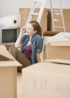 Woman talking on cell phone in new house. Date : 2006