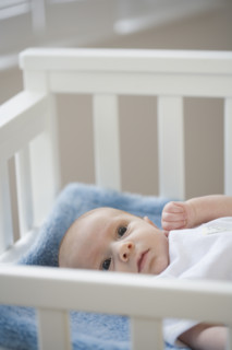 Baby laying in crib. Date : 2007