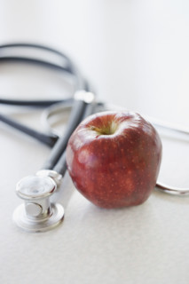 Close up of apple and stethoscope. Date : 2006