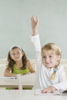 Young girl raising hand in class. Date : 2006