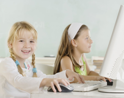 Two young girls using computers. Date : 2006