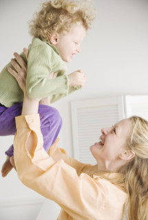 Mother playing with her daughter. Date : 2006