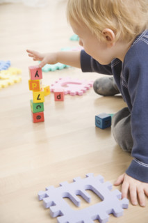Toddler stacking blocks. Date : 2006