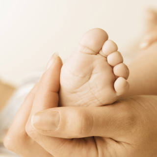 Close up of baby’s foot in mother’s hand. Date : 2006