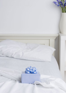 Still life of gift box on bed. Date : 2006