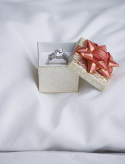 Still life of diamond ring on pillow. Date : 2006