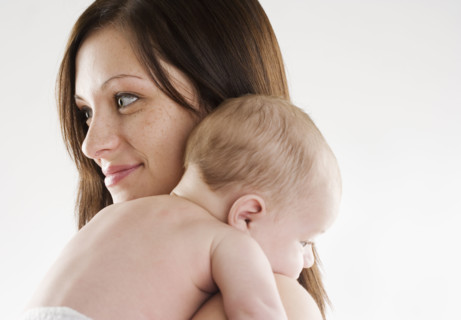 Mother holding baby on her shoulder. Date : 2006