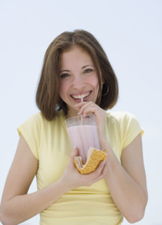 Woman drinking milkshake with straw. Date : 2007