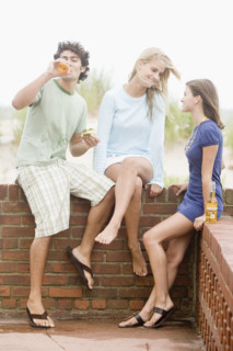 Friends leaning on brick wall. Date : 2007