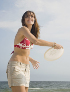 Woman playing game at beach. Date : 2007