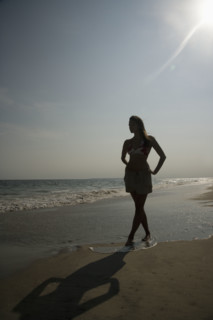 Woman walking on beach. Date : 2007