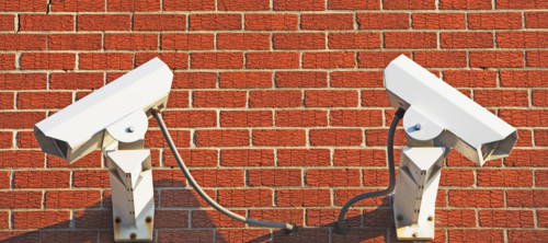 Security cameras on brick wall. Date : 2007