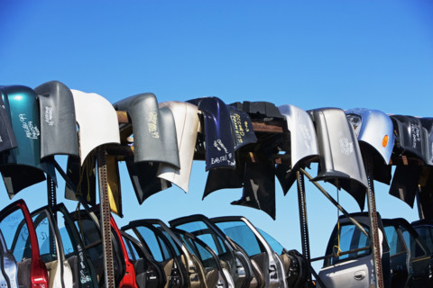 Car doors and bumpers at junkyard. Date : 2007