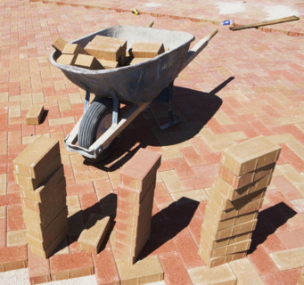 Wheelbarrow and bricks on new patio. Date : 2007