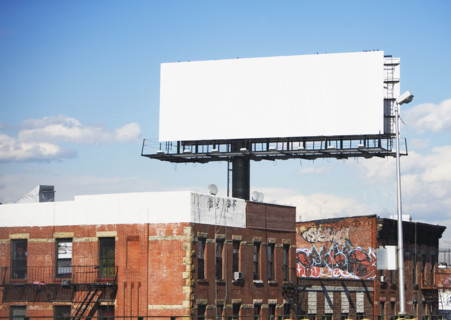 Blank billboard over urban buildings. Date : 2007