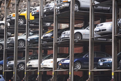 Cars stacked in urban parking lot. Date : 2007